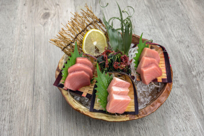 Top view of tuna sashimi set include Otoro, Chutoro and Akami with ice on the table, Luxury Japanese food concept