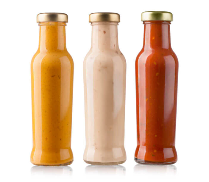 the various barbecue sauces in glass bottles