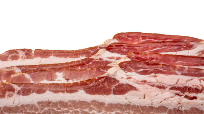 background of uncured sliced bacon on white