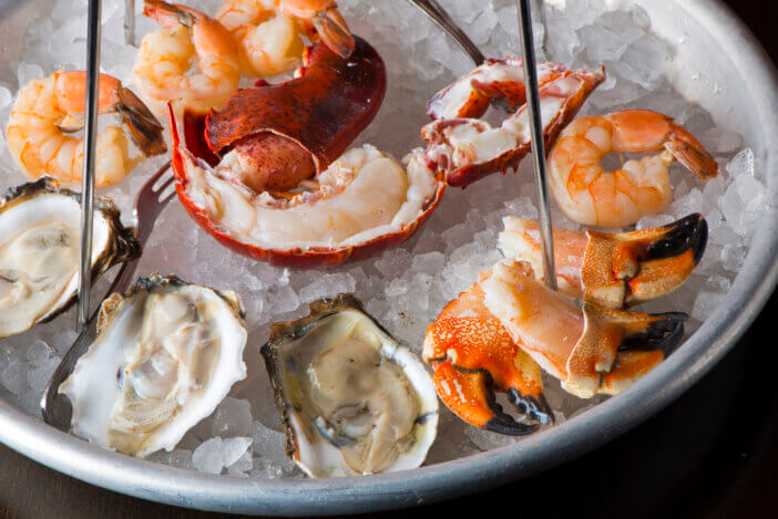 Oysters, shrimp, lobster, crab legs, caviar. Fresh oysters served with shallots and cocktail sauce, mignonette sauce and fresh lemons and limes. Classic American steakhouse or French bistro appetizer.
