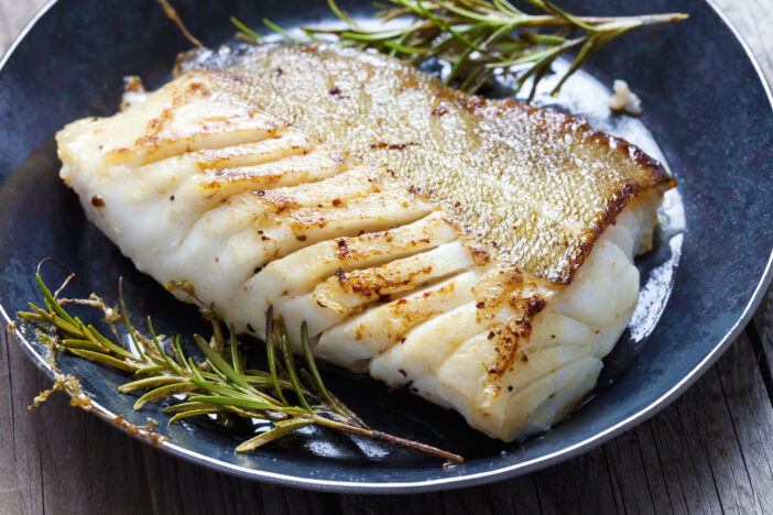 Fried fish fillet, Atlantic cod with rosemary in pan