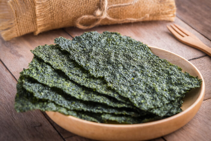 Crispy dried seaweed on wooden plate