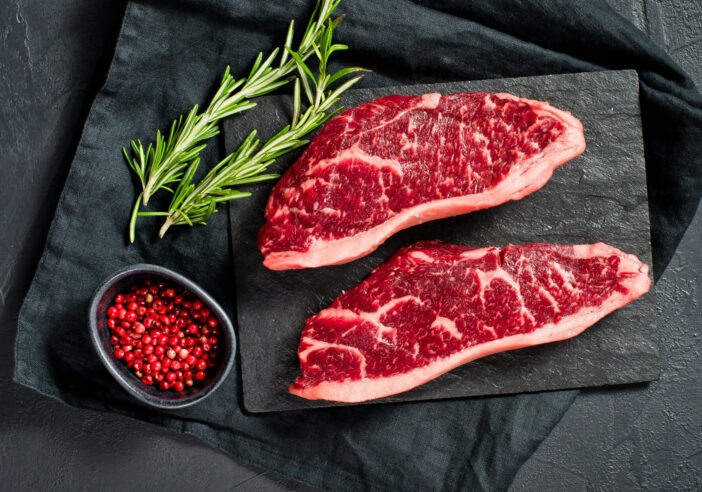 Steak of marbled beef black Angus. Black background, top view