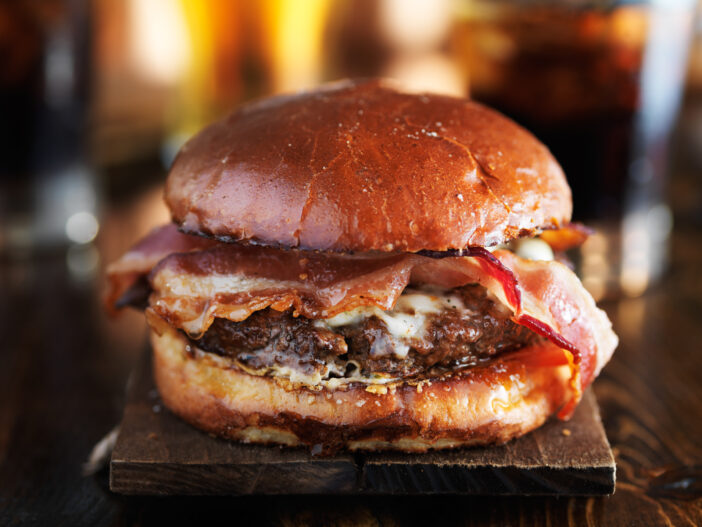 juicy gourmet cheeseburger with melted pepper jack and strips of crispy bacon