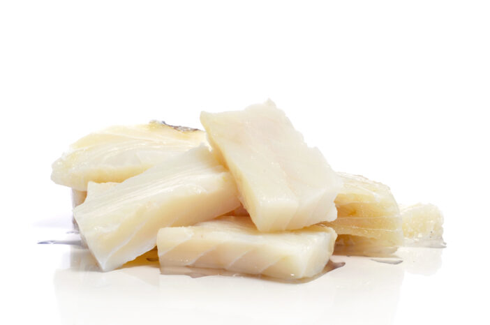 some pieces of raw cod on a white background