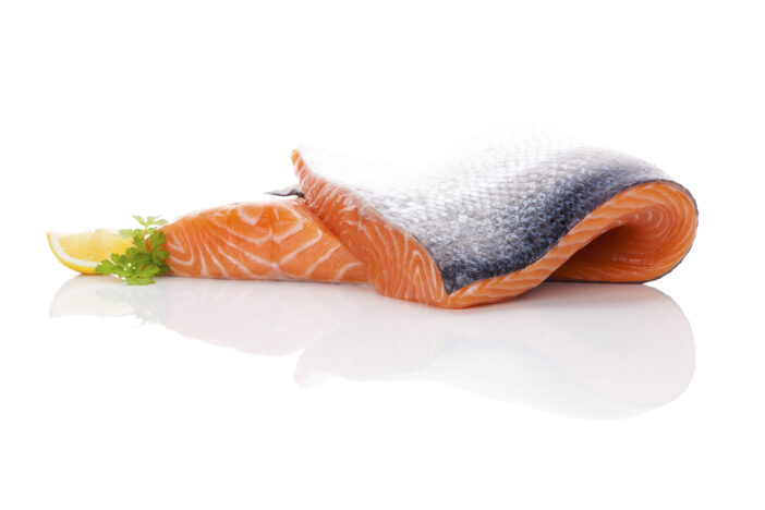 Raw salmon steak isolated on white background. Sashimi sushi. Luxurious healthy seafood eating.