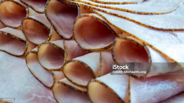 Black Forest Ham that is rolled up to fit on a serving tray,  For house guess, or display, or just plain eating.  The photograph is letter box format.