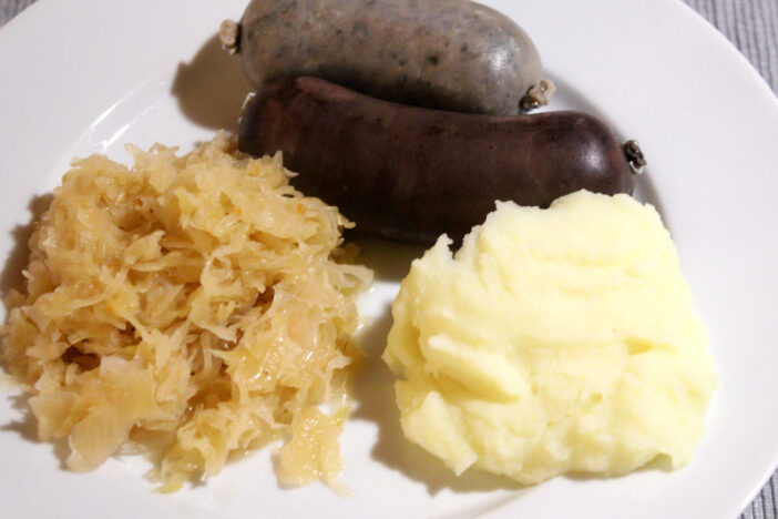 Blood and liver sausage, served with sauerkraut and mashed potatoes. A special delicacy, a hearty Bavarian specialty.  Close-up with selected focus.