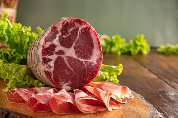 Capocollo or coppa is a traditional Italian and Corsican pork cut made from cured pork shoulder or neck. . Cut into very thin slices. Italian delicacy for aperitivo. Piacentina DOP.