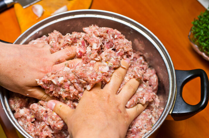 Mixing minced meat by hands