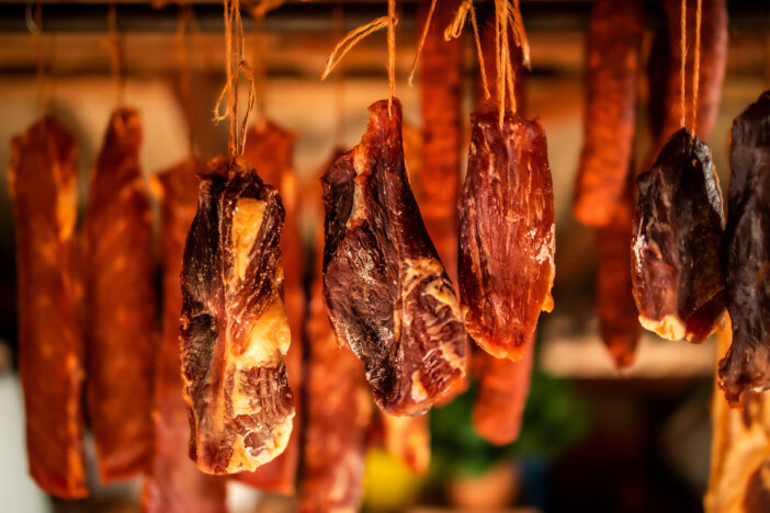 Smoked prosciutto hanging. Homemade food production.