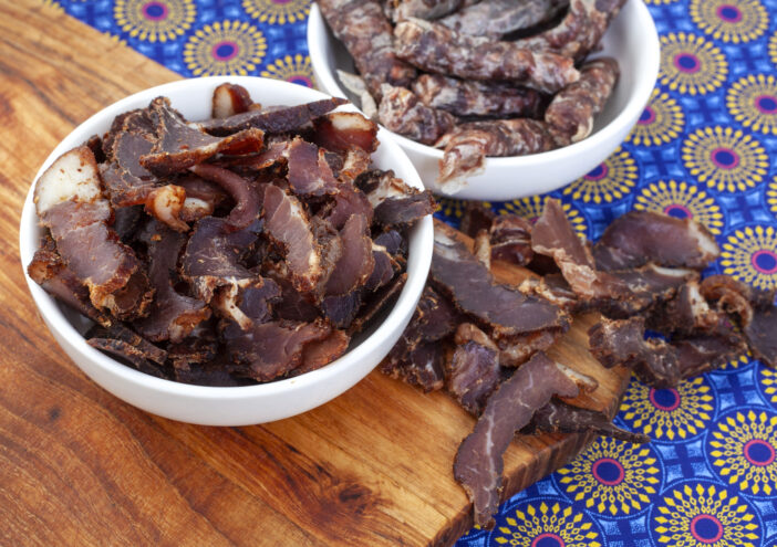 South African Traditional Biltong and dry wors on blue traditional printed cloth.