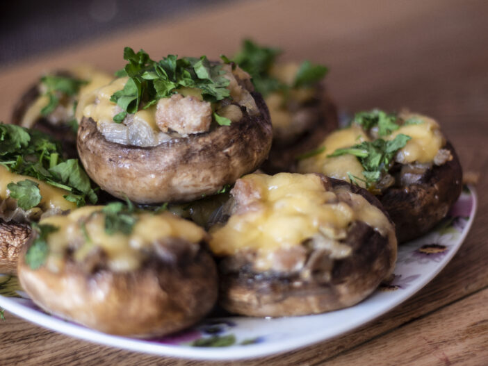 Stuffed mushrooms on a rough wooden surface