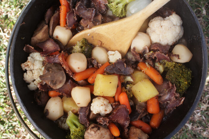 Top view of a unfinished biltong and beef potjie. Potjiekos is a typical lazy Sunday Lunch in South Africa.