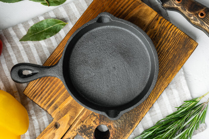 Empty frying cast iron pan background, kitchenware cooking concept set, on white stone  surface, top view flat lay, with copy space for text