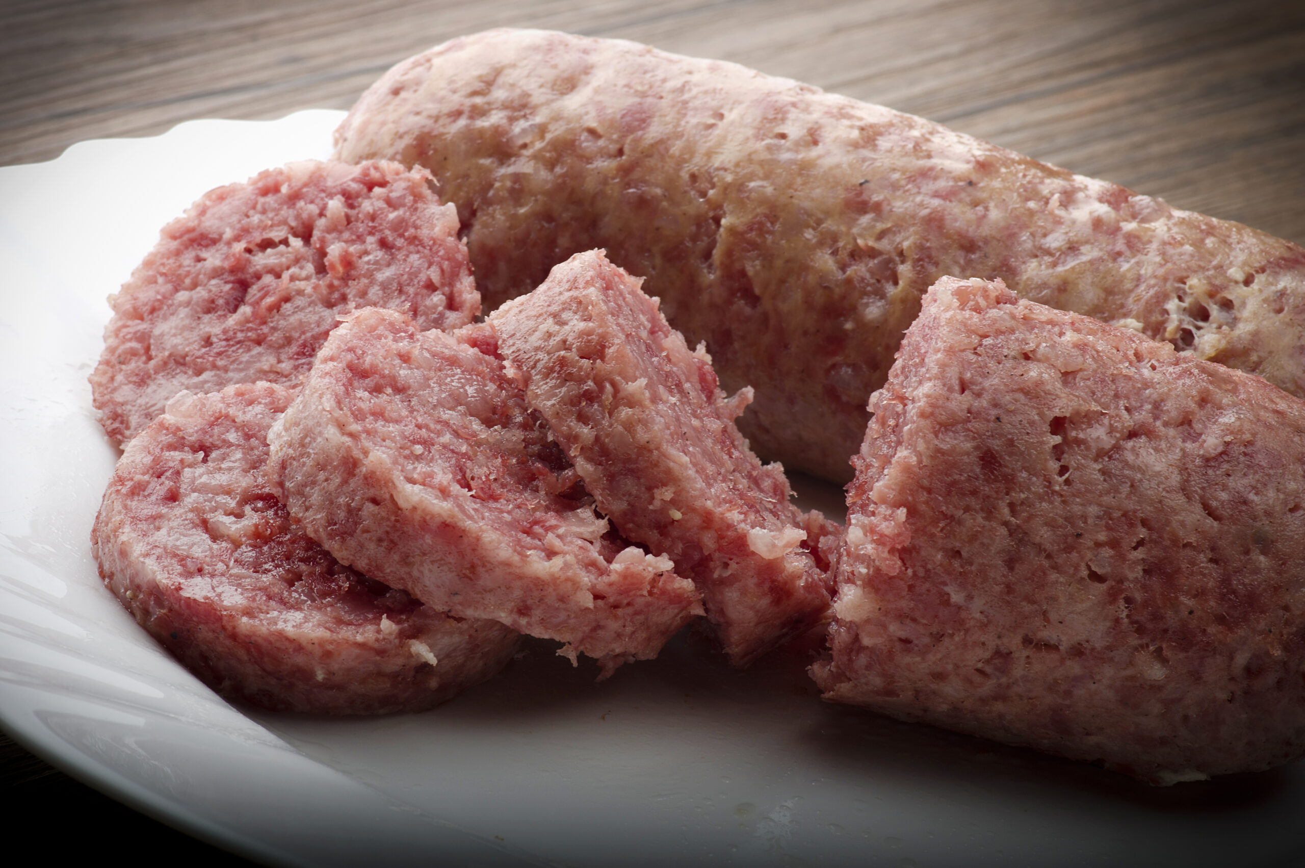 pork sausage (cotechino) with polenta on the wood table