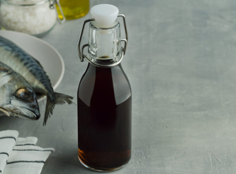 prepared by fermentaion of fish salty sauce garum in a bottle on grey background