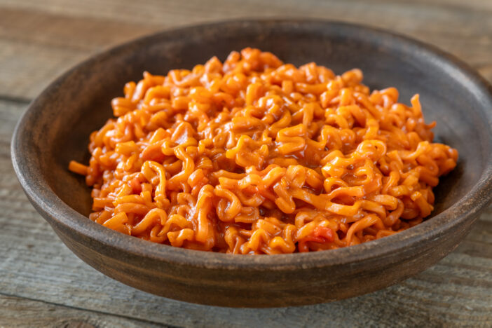 Bowl of Gochujang butter noodles on wooden background