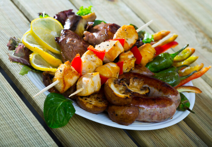 Plate  of dish bulgarian cuisine meshana scara with different grilled meat and vegetables