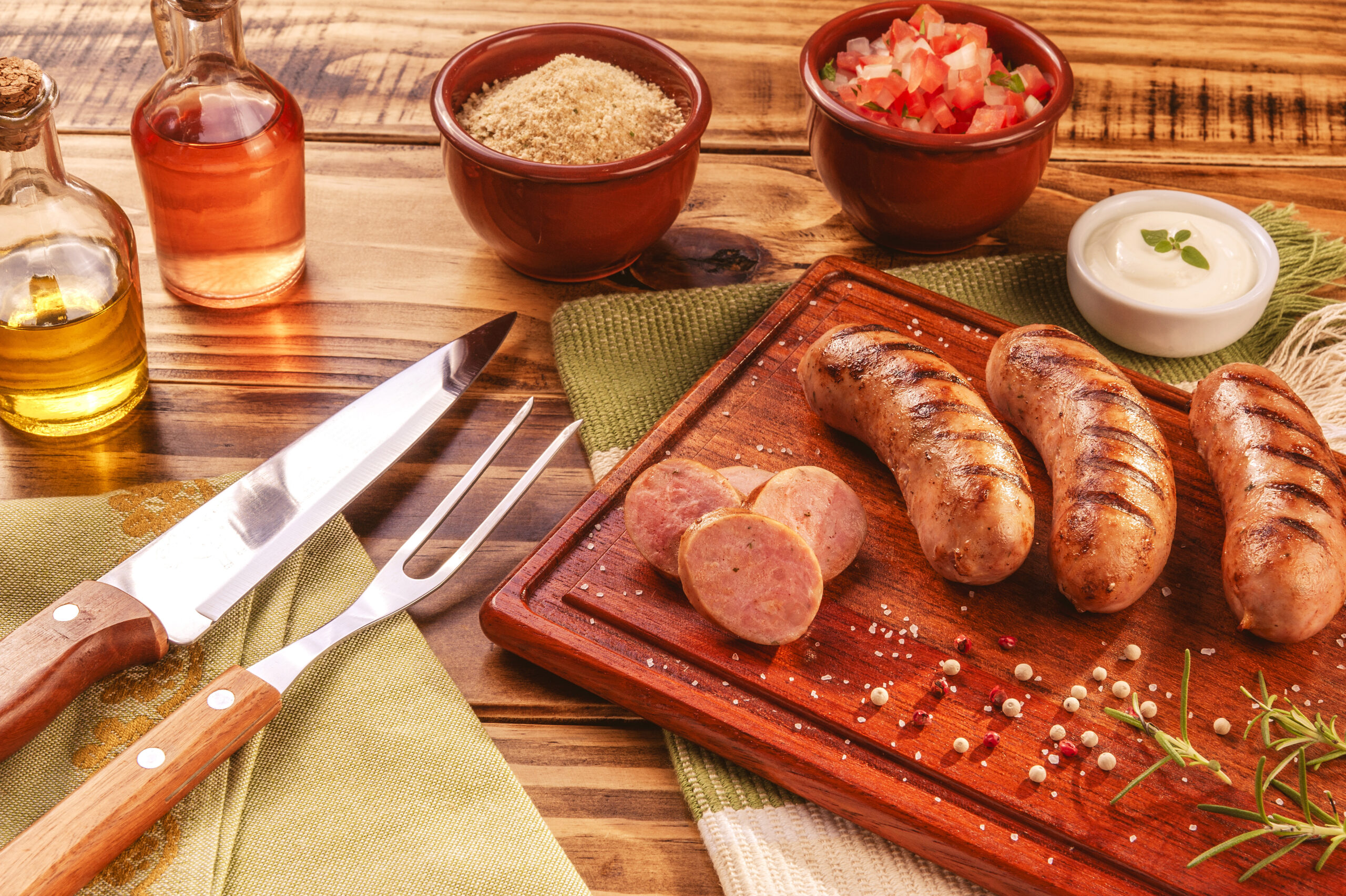 Brazilian pork sausage with BBQ fork and knife - Churrasco de linguiça de suina