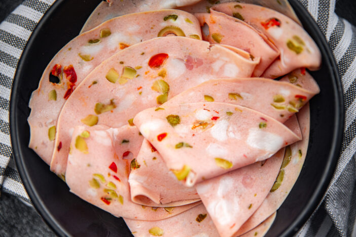 mortadella pieces marinated vegetables boiled sausage olives, pickled cucumber, pepper, gherkin healthy eating cooking appetizer meal food snack on the table copy space food background rustic top view