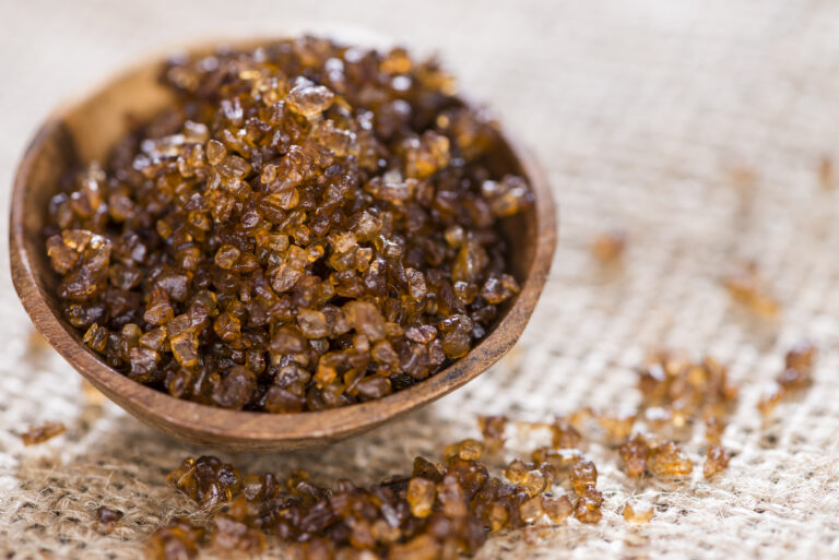 Heap of Smoked Salt on rustic wooden background