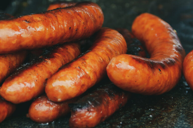 Nutritious smoked sausages cooked on the grill at an outdoor stall next to Bran Castle in Romania.