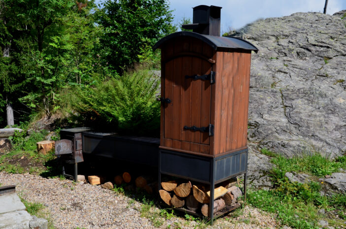 grill and smokehouse for meat, sausages, salami. smoking is a way of preserving food with hot smoke from natural wood. the process takes several hours, mountains, rock, stone