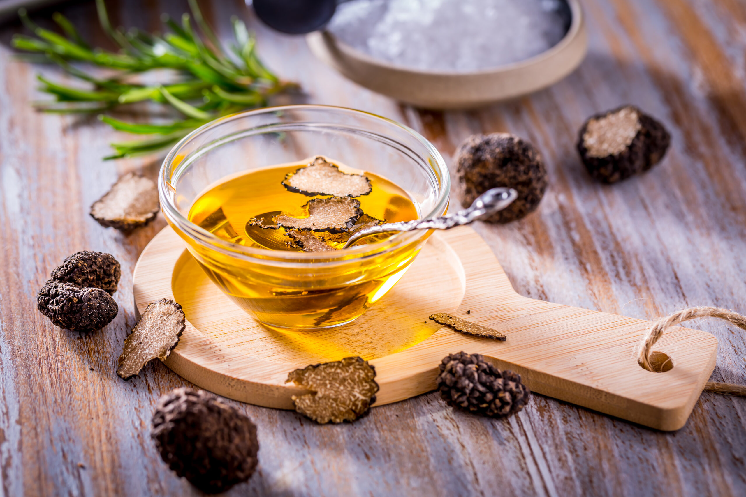 Truffle mushroom oil on wooden background. Gourmet food.