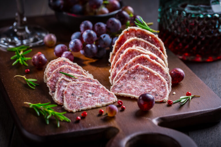 Saltufo - Italian salami delicacy, salami with summer truffle coated with Parmesan cheese with red wine and grapes