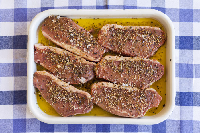 Beautiful steak pieces in marinade with spices.