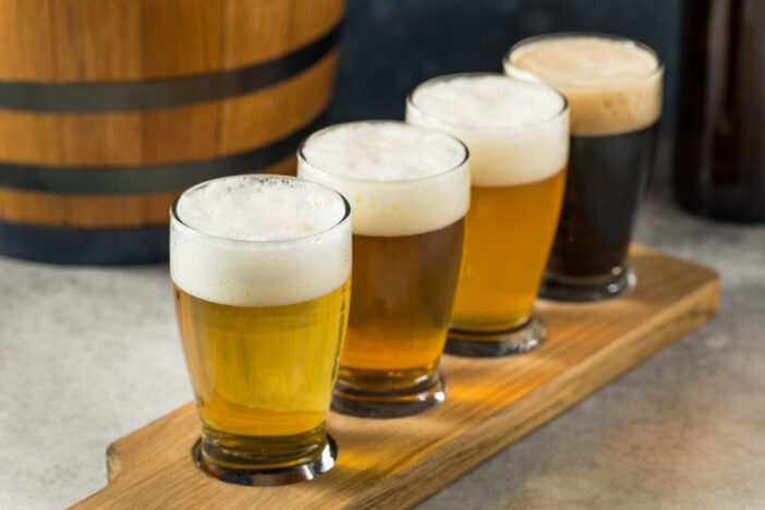 Boozy Refreshing Cold Craft Beer Flight with an IPA and Lager