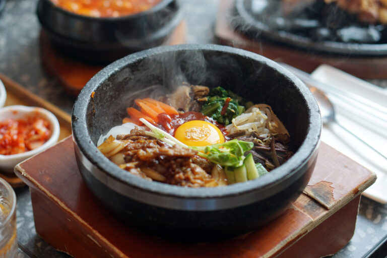 Dolsot bibimbap - Korean mixed rice, Include steamed rice, vegetables, pork and fried egg on top, served in a hot stone pot, Dolsot means stone pot in Korean.