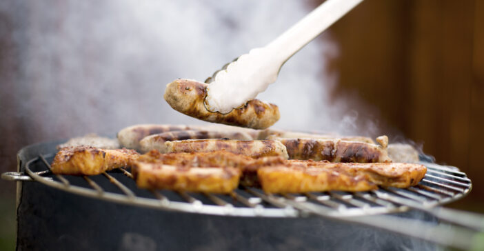 Grilling at summer weekend. Fresh juicy  sausages and chicken