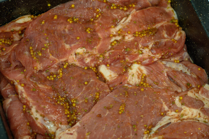 Marinated pork with whole mustard seeds