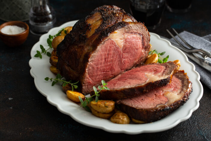 Boneless beef roast on a serving platter sliced for a holiday dinner