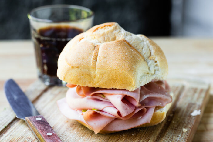 mortadella sandwich on cutting board closeup