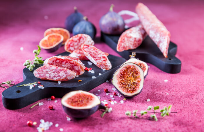 Spanish salami fuet with fresh figs - dry-cured and natural fermented sausages