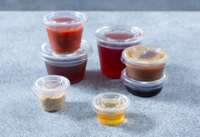 A view of several varieties of plastic condiment cups.