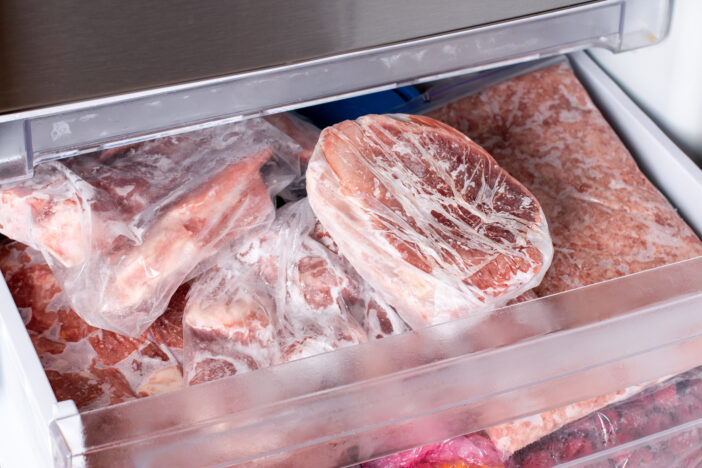 Raw frozen meat. Raw pork chops in the freezer. Frozen food