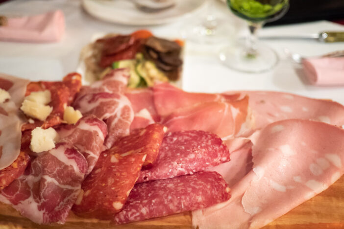 Assortment of tasty and delicious Italian antipasto. Prosciutto di Parma or Parma ham, Chorizo, Salami sausage, Bologna with cheese. A perfect appetizer, party snack, or good accompany with wine.