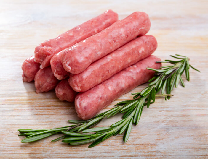 Traditional Catalan raw pork sausage botifarra ready for grilling on wooden board