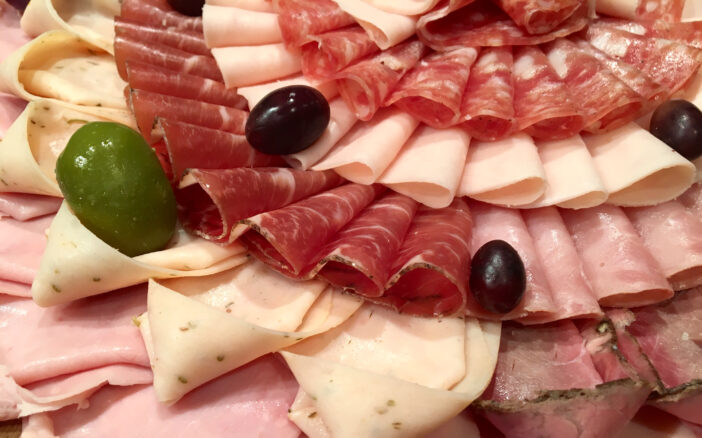 A large portion of thin slices of assorted cold cuts