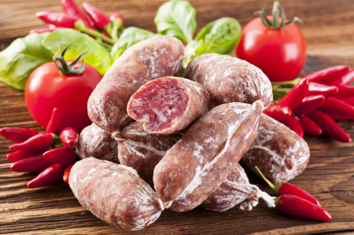 Air-dried salami as closeup on a wooden table