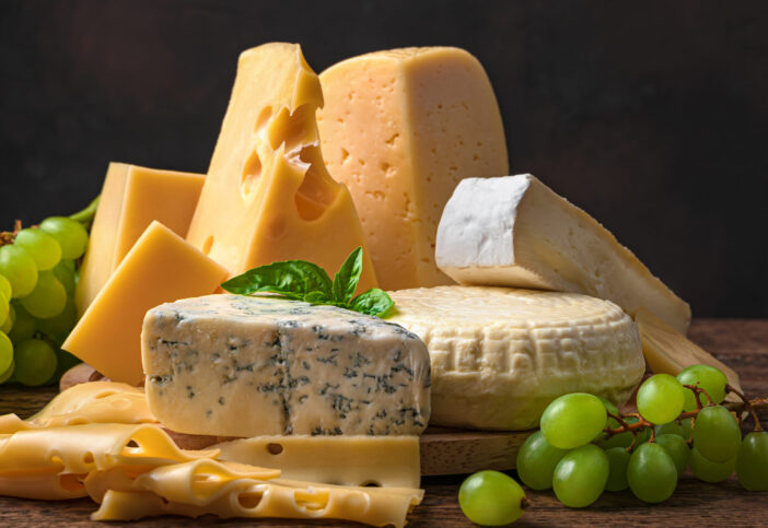 Different types of sarah on a wooden background. Assortment of cheeses. Side view.