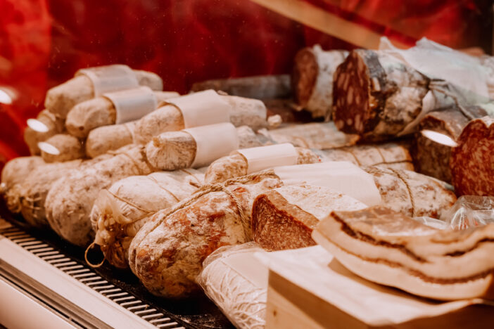 Assortment of smoked sausage and salami in a supermarket. Delicacy and butchery shop