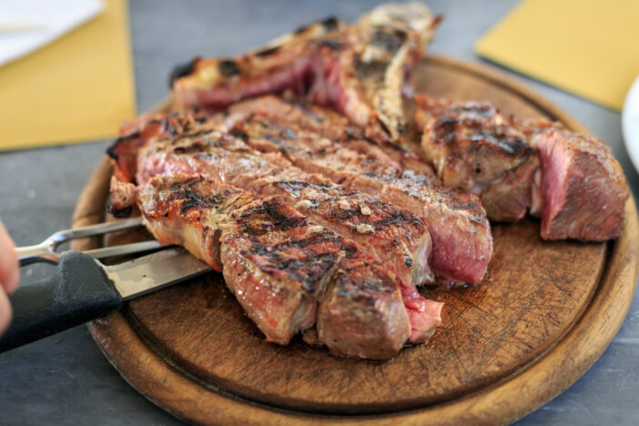 T-bone steak, Bistecca all Fiorentina,  is served in restaurant of Florence