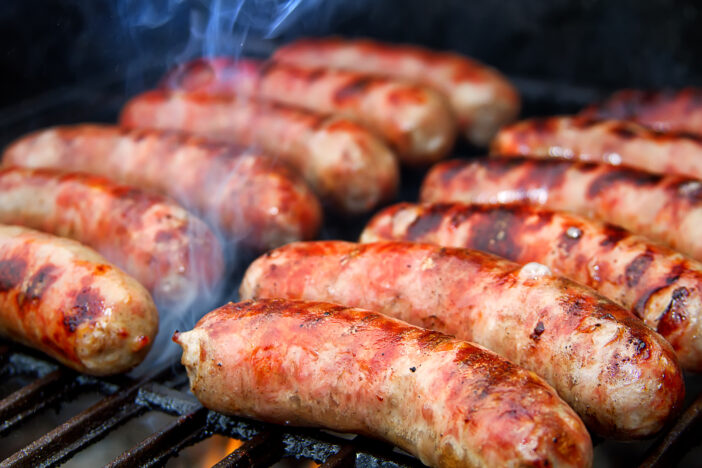 Delicious German sausages on the barbecue grill