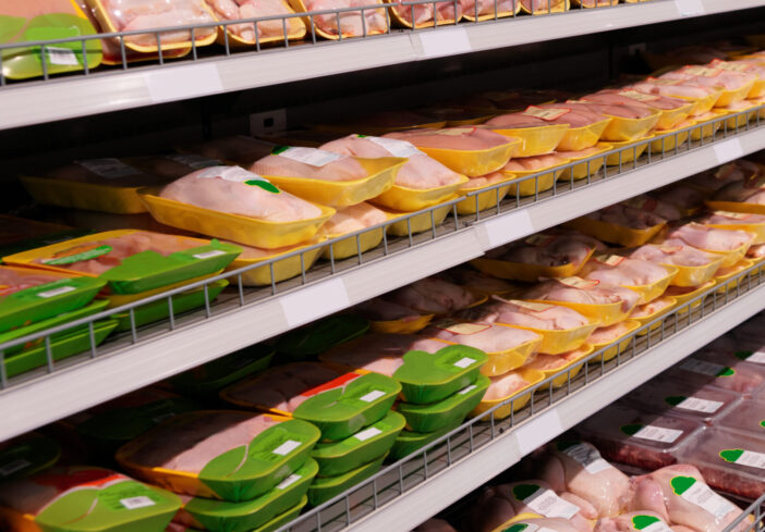 Fresh chicken meat on supermarket shelf, all logos removed