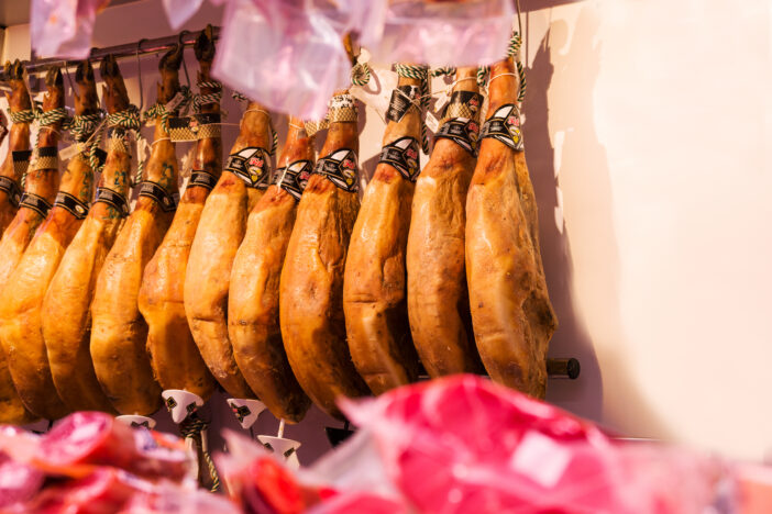 Fresh jamon weighs in the Boqueria market i